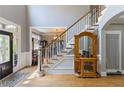 Inviting foyer with hardwood floors, stairs and a decorative mirror adding to the home's character at 1029 Laurel Grove Cts, Suwanee, GA 30024
