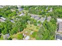 Aerial view of the property within the red lines, surrounded by lush green trees and urban buildings at 110 Barnesdale Ter, Woodstock, GA 30188