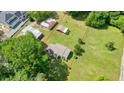 Aerial view of a home with spacious backyard, outbuildings, and perimeter outlined in red at 110 Barnesdale Ter, Woodstock, GA 30188