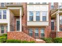 Charming brick townhome with steps leading to a welcoming entrance and well-maintained landscaping at 3585 Adelaide Xing, Brookhaven, GA 30319
