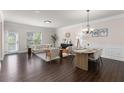 Bright living and dining area featuring hardwood floors, neutral paint, modern furniture, and ample natural light at 3585 Adelaide Xing, Brookhaven, GA 30319