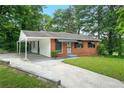 Cozy one-story brick home featuring a convenient carport and tidy front yard at 3698 Fairlane Nw Dr, Atlanta, GA 30331