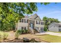 View of the home with stone accent and front yard with natural landscaping features at 3835 Annandale Ln, Suwanee, GA 30024