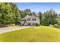 Inviting two-story home with a spacious front yard and driveway leading to a charming facade with well-manicured landscaping at 3835 Annandale Ln, Suwanee, GA 30024