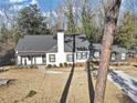 Beautiful home featuring a gray roof, white and gray paint, a chimney, and a manicured lawn at 1571 Boulevard Lorraine Sw, Atlanta, GA 30311