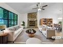 Bright living room with a stone fireplace and a large window overlooking the backyard at 2325 Sebring Sw Ct, Marietta, GA 30064