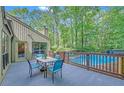 A cozy deck featuring outdoor seating with a view of the pool and backyard at 2505 Oakrill Rd, Marietta, GA 30062