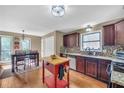 Well-lit kitchen with stainless steel appliances, granite countertops, and hardwood floors at 2505 Oakrill Rd, Marietta, GA 30062