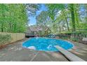 Beautiful backyard pool with diving board surrounded by lush landscaping and mature trees at 2505 Oakrill Rd, Marietta, GA 30062