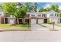 Charming townhome featuring a brick front, a well-manicured lawn, and a convenient two-car garage at 3453 Dianthus Ln, Lawrenceville, GA 30044