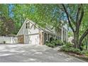 Long driveway leading to a spacious two-car garage complementing the main house at 6300 Mountain Brook Ln, Atlanta, GA 30328