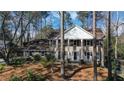 Two-story brick home with a symmetrical facade, white pillars, and a well-manicured lawn at 6300 Mountain Brook Ln, Atlanta, GA 30328