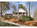 Two-story brick home featuring a landscaped yard and driveway, surrounded by mature trees at 6300 Mountain Brook Ln, Atlanta, GA 30328