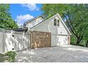 Side view of a two car garage with brick and white siding, showing its spacious driveway at 6300 Mountain Brook Ln, Atlanta, GA 30328