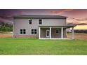 Spacious backyard featuring a covered patio, perfect for outdoor relaxation and entertaining with ample space for recreation at 133 Canal St, Hampton, GA 30228