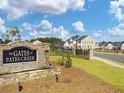 Stone sign marking the entrance to The Gates at Pates Creek community at 133 Canal St, Hampton, GA 30228