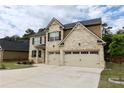Attractive brick home boasts a two-car garage and lush green lawn at 133 Canal St, Hampton, GA 30228