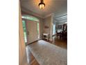 Warm, naturally lit foyer showcasing hardwood floors and a decorative console table at 1502 La Fayette Pl, Loganville, GA 30052