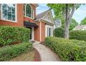 Close-up of a home's entryway featuring brickwork, a neatly landscaped walkway, and a welcoming entrance at 1996 Wellesley Trce, Atlanta, GA 30338