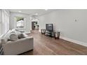 Bright living room featuring hardwood floors, a comfortable sofa, and large windows at 2025 Venetian Sw Dr, Atlanta, GA 30311