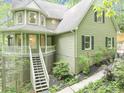 Inviting exterior of a two-story home featuring a front porch, stairs, and well-maintained landscaping at 284 Due West Ct, Dallas, GA 30157
