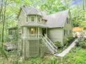 Charming two-story home with a unique turret and welcoming front porch surrounded by lush greenery at 284 Due West Ct, Dallas, GA 30157