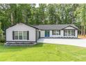 Charming white modern farmhouse with a well manicured lawn and large driveway at 2265 Hillbriar Dr, Buford, GA 30518
