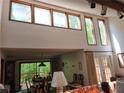 Bright and airy living room boasting high ceilings, large windows, and a dining area with serene views at 363 Weatherstone Ln, Marietta, GA 30068