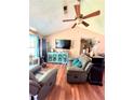 Comfortable living room with hardwood floors, a ceiling fan, and plenty of natural light at 107 Honeysuckle Ln, Stockbridge, GA 30281