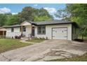 A nicely renovated one-story home featuring white brick, dark roof, and fresh landscaping at 1340 Juneau Ct, Tucker, GA 30084