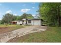 Wide shot of the home showcasing the driveway and front yard at 1340 Juneau Ct, Tucker, GA 30084
