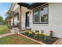 Close-up view of the front porch with decorative iron railings and fresh landscaping at 1340 Juneau Ct, Tucker, GA 30084