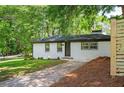 Newly renovated single-story home featuring a fresh white brick exterior with black trim at 1678 Capistrana Pl, Decatur, GA 30032