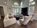 Bright living room with high ceilings and oversized windows, features a fireplace and dark floors at 3050 Camden Way, Alpharetta, GA 30005