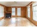 Spacious living room with hardwood floors, a fireplace, and lots of natural light from the many windows at 4507 Laurie Ln, Powder Springs, GA 30127