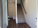 Inviting entryway featuring hardwood floors and a staircase leading to the upper level at 1616 Avery Way, Tucker, GA 30084