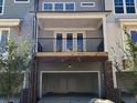 A two car garage with a balcony above and brick columns supporting the structure at 1616 Avery Way, Tucker, GA 30084