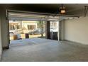 Open two car garage with poured concrete floors, insulated garage door, and unfinished walls at 1616 Avery Way, Tucker, GA 30084