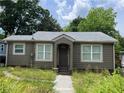 Charming single-story home with grey siding, a grey roof, and well-lit windows at 184 Scott Nw St, Atlanta, GA 30314
