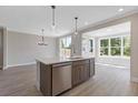 Modern kitchen with stainless steel appliances, island with sink, and abundant natural light at 1954 William Glen St, Dacula, GA 30019