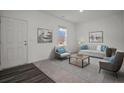 Bright living room with modern furnishings, neutral walls, and a large window with a view at 2349 Argento Cir, Dacula, GA 30019