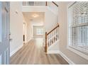 Inviting entryway with hardwood floors, a staircase, and views into the adjacent rooms at 909 Pine Cove Dr, Lilburn, GA 30047