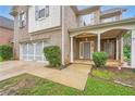 Traditional brick home with a covered front porch, two-car garage and well-maintained landscaping at 909 Pine Cove Dr, Lilburn, GA 30047