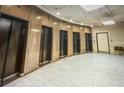Elevators stand along a hall with marble floors, wood-like walls, and recessed ceiling lights at 20 Marietta Nw St # 10 F, Atlanta, GA 30303