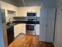 A well-lit kitchen with white cabinets, stainless steel appliances, and dark countertops at 20 Marietta Nw St # 10 F, Atlanta, GA 30303