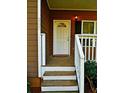 Welcoming front porch with a white door and stairs, adding curb appeal at 207 Brownlee Sw Rd, Atlanta, GA 30331