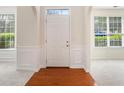 Bright foyer features hardwood floors, white wainscoting and arched entryways at 4535 Howell Farms Nw Rd, Acworth, GA 30101