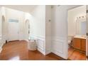 Light-filled foyer with wood floors, glass table, and half-bathroom access at 4535 Howell Farms Nw Rd, Acworth, GA 30101