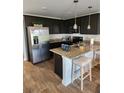 Modern kitchen featuring granite countertops, stainless steel appliances, and dark wood cabinets at 4839 Station Lane -Lot 31, Union City, GA 30349