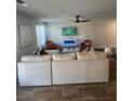 Bright living room with a large sofa, stylish decor, a ceiling fan and an electric fireplace at 4839 Station Lane -Lot 31, Union City, GA 30349